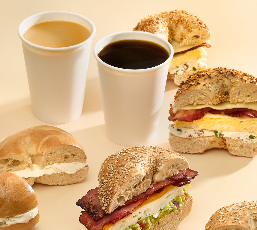 Twenty Schmear bagel varieties laid out in a grid, including everything, poppy, salt and a rainbow bagel